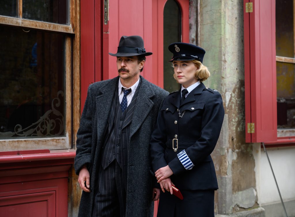 Sam Rockwell and Saoirse Ronan walking the streets of London
in the film See How They Run (2022). The film releases September 16 in the USA and has released on September 9 in the UK.